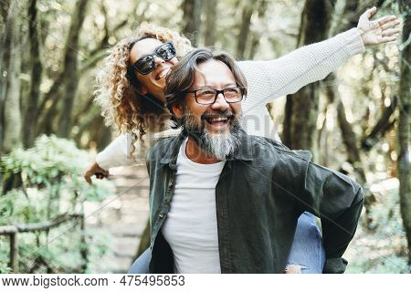 Youth Mature People Having Fun Together In The Natural Park In Green Nature Scenic Place With Trees 