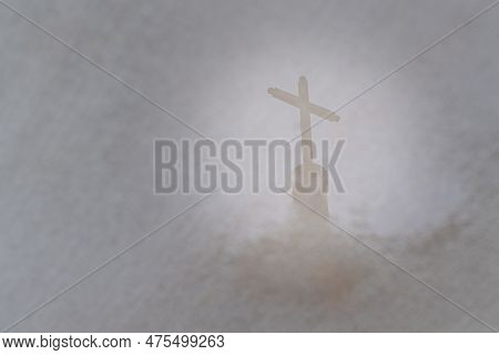 Cross On A Church Reflects Into A Puddle Of Water