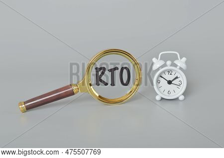 Clock And Magnifying Glass With Text Rto Stands For Recovery Time Objective