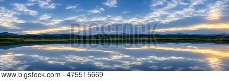 Evening Cloudy Sky Reflected In Lake. Cloudscape. Clouds In Blue Sky And Reflection In Large Lake. W