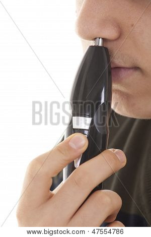 Close Up Man Portrait With Trimmer Near His Nose
