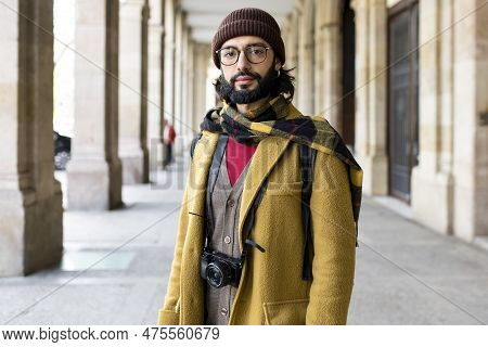 Portrait Of A Fashion Tourist Man On The Street Looking At Camera. Handsome Bearded Traveler Standin