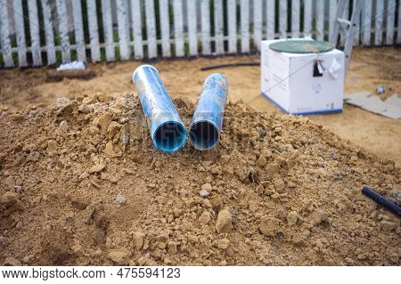 Two Plastic Pipes Dropped On The Ground During Dewatering Excavation, Outdoor Shot