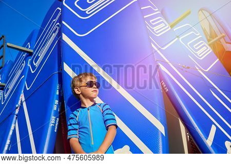 Confident Cool Caucasian Model Guy Poses In Front Of The Camera On The Beach Against The Background 