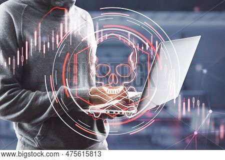 Close Up Of Hacker Hands Using Laptop Computer With Abstract Glowing Skull Hologram On Blurry Office