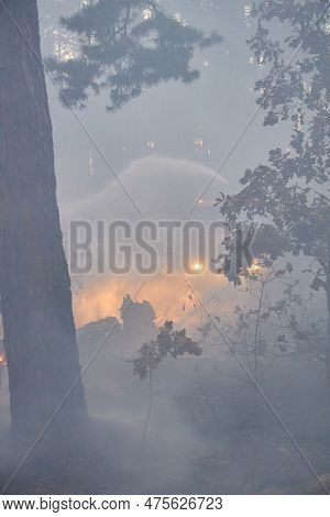 Water Cannon Of A Fire Engine Shooting A High-velocity Stream Of Water, Firemen Fighting Fire In For