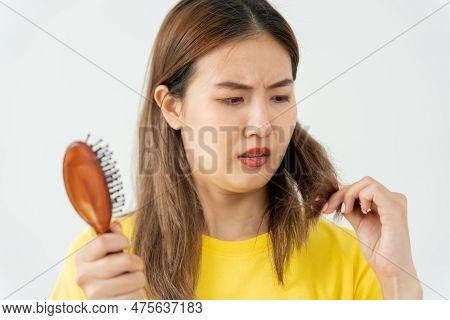 Asian Woman Very Sad And Upset Looking At Damaged Hair, Hair Loss, Hair Thinning Problem, Vitamin De