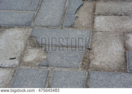 Broken And Cracked Paving Stones.
Damaged Pavement Need Repair.