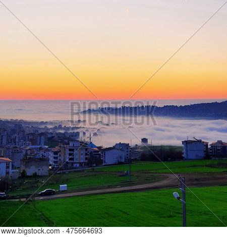 A Photo Featuring A Sunrise With Clouds In The Sky Is A Stunning And Captivating Image. The Soft, Wa
