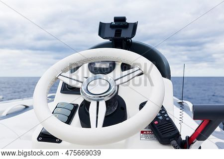 Motor Boat Control Panel. Steering Wheel, Gear Levers And Control Buttons.