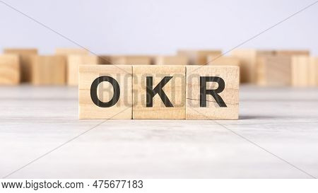 Okr - Word Concept Written On Wooden Cubes Or Blocks On A Light Background
