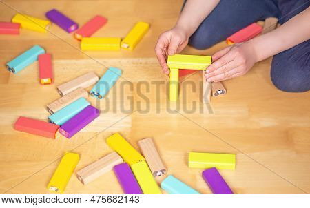 Child Sitting On The Ground In The Flat And Playiing With Colorful Toy Blocks. Educational Game.