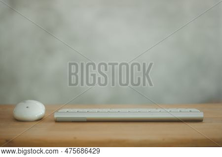 Computer Workplace. Mouse And White Keyboard On The Wooden Desk With Copy Space, Office Concept, Sel