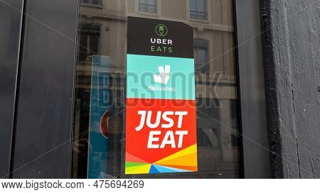 Lyon , Aura France - 04 20 2023 : Just Eat Deliveroo Uber Eats Sign Brand And French Text Logo On Wi