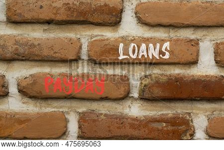 Payday Loans Symbol. Concept Words Payday Loans On Beautiful Red Brown Brick Wall On Beautiful Red B