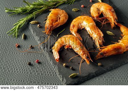 Caridea Or Boiled Shrimps With Rosemary On A Gray Table. The Idea Of Delicious Dietary Seafood For L
