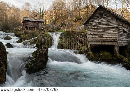 Mountain River With Mossy Rocks And Wooden Watermills In Long Exposure, River Krupa In Krupa Na Vrba