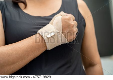 Asian Woman Use Elastic Bandage To Treating De Quervain Syndrome At Hand And Finger In Office.