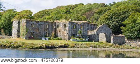 Ruins Of An Ancient Stone Building On The Shore In Ireland On A Sunny Day. The Ruins Of Arundel Grai