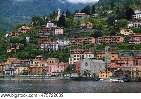 A Landscape With A View Of Lake Como And The Chiesa Santissima Trinita Church In The Town Of Argegno