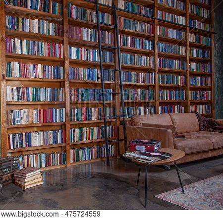 Books On Bookshelves In An Empty Library Room. Book Background. Knowledge And Study At Home. Cozy In