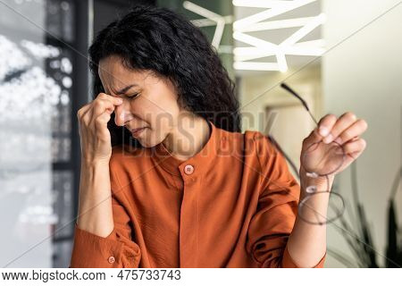 Overworked Hispanic Business Woman Working Inside Modern Office Building, Female Worker Removed Glas