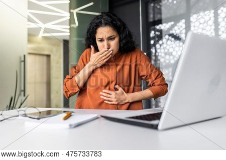 Businesswoman Has Severe Nausea, Latin American Woman At Work Sick, Working Sitting At Table With La