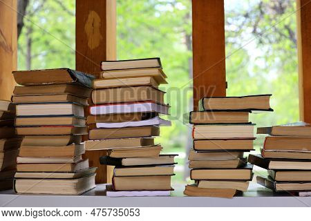 Stacks Of Books In A Park For Bookcrossing. Background For Literature, Bookstore, Library