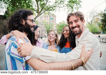 Group Of Young Adult Multiracial People Having Fun Together Hugging Each Others. Joyful Happy Man Si