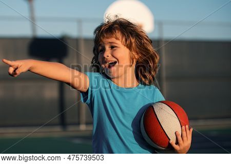 Happy Smilin Kid Playing Basketball, Pointing Showing Gesture. Activity And Sport For Kids.