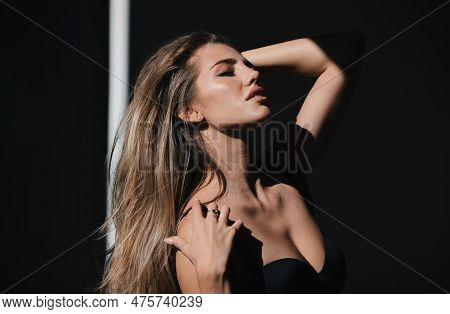 Portrait Of Beautiful Woman Model Looking Seductive And Sensual. Beauty Face With Dramatic Studio Li