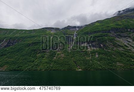 Little Waterfall. Views Inside The Geiranger Fjord Taken By The Ferry Hellesylt Geiranger. July 2019