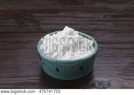 Starch In Bowl On Wooden Table, Closeup