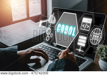 Cobol, Common Business Oriented Language, Person Working On Laptop Computer With Cobol Icon On Virtu