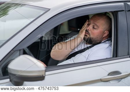 Tired Overweight Man Drives Car With Broken Air Conditioner In Hot Summer Weather. Male Wiping Sweat