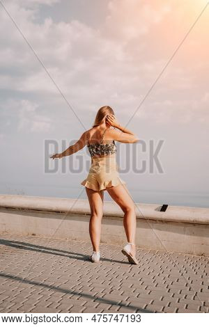 Woman Summer Dance. Silhouette Of A Happy Woman Who Dances, Spins And Raises Her Hands To The Sky. A