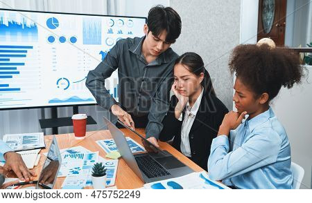 Diverse Businesspeople Analyzing Financial Dashboard Data On Laptop In Serious Meeting, Confused And