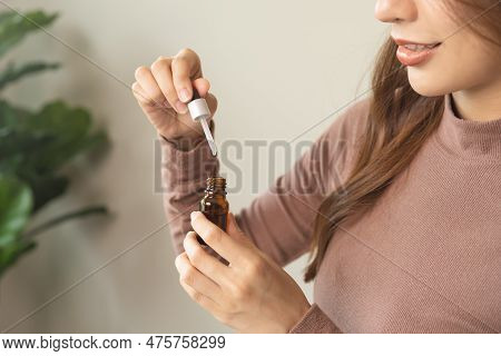 Aromatherapy, Cute Asian Young Woman Hand Hold Bottle Of Essential Perfume And Drop Oil, Enjoying Sm