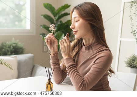 Aromatherapy, Cute Asian Young Woman, Girl Holding Flower, Bottle Of Essential Perfume Oil, Enjoying