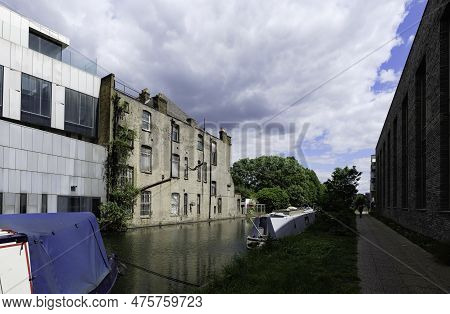 London - 05 21 2022: Houseboats Moored On The Grand Union Canal Near Adela St With Mallard Duck In F