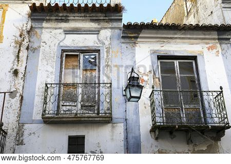 Old Houses With White Chipped Facades In Evora Town, Portugal