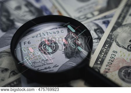 Stock Market Chart Inside Magnifier Glass On Benjamin Franklin Face Of Usd Banknote For Focus And An