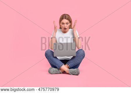Emotional Woman With Laptop On Pink Background