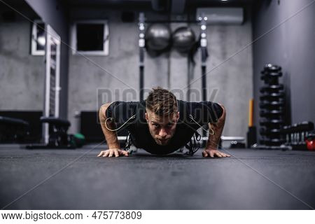 A Male Fitness Coach In A Special Suit For Ems Technology Performing Arm And Chest Exercise And Push