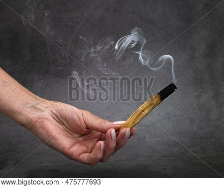 Palo Santo Burning In Front Of Dark Background