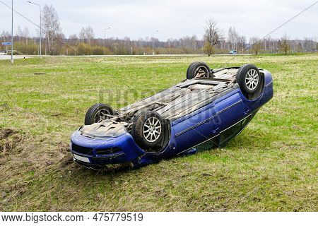 Car Accident Scene, A Passenger Car Left The Road And Overturned With Its Wheels Up, Overturned Car