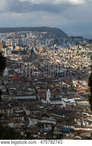 Aerial View Of Quito From Cerro El Panecillo. Plaza Grande With Its White Building In The Center