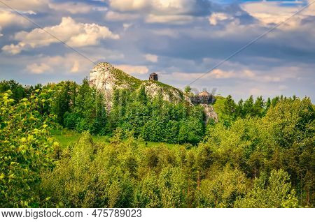 Highland Landscape In Summer Scenery. Man Climbing On Jurassic Limestone Rock, Situated Highland Are