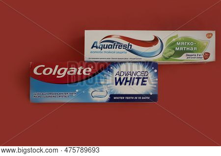 April 25, 2023 Ukraine City Kyiv Toothpaste Colgate And Aquafresh On A Colored Background