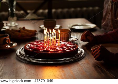 Happy Child, Celebrating Eight Years Birhtday With Homemade Birthday Cake With Strawberries And Burn
